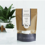 Package of shower steamers beside two potted plants