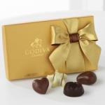 Gold gift box with a ribbon and assorted chocolates