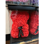 Red rose teddy bear in a clear gift box with a black ribbon