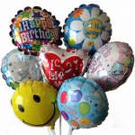 Cluster of colorful birthday and love-themed foil balloons