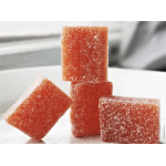 Stacked orange-red sugar-coated gummy candies on a white plate