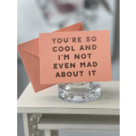 Peach greeting card in a clear glass holder with bold text
