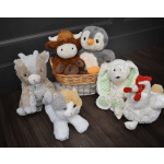Assorted plush animals arranged on the floor, including a cow, penguin, bunny, cat, and chicken.