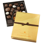 Box of assorted chocolates with a gold lid and brown ribbon