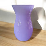 Lavender glass vase on a wooden surface