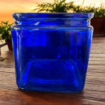 Blue glass jar on a wooden surface