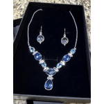 Blue gemstone necklace and matching earrings in a black gift box