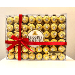 Box of Ferrero Rocher chocolates tied with a red ribbon