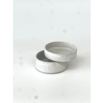 Two white ceramic bowls stacked on a white surface