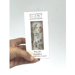 Packaged pillar candle with a floral print