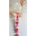 Cluster of peach and clear balloons with pink tassels