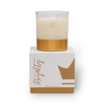 White and gold scented candle in a glass jar on a box