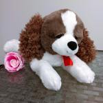 Plush dog with a pink rose beside it