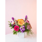Colorful mixed flower arrangement in a white vase