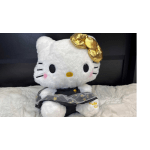 Hello Kitty plush toy with a gold bow and black dress