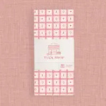 Pink patterned gift wrap with a white center panel and logo