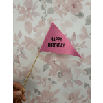 Pink felt birthday pennant on a wooden stick against a floral background