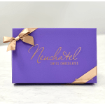 Purple box of Neuchatel Swiss chocolates tied with gold ribbon