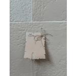 A sympathy card tied with twine on a clear plastic stake