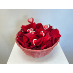 Basket of red rose petals with small heart decorations