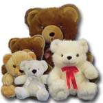 Four teddy bears in brown, white, and tan plush