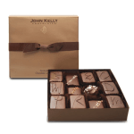 Square gold gift box with brown ribbon and assorted gourmet chocolates in an open tray.