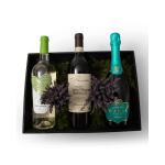 Gift box with three assorted wine bottles nestled in moss with purple dried sprigs