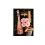 Gift box with pink sparkling wine, pink roses, macarons, and chocolates