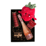Gift box with strawberry plush, pink sparkling wine, macarons, and chocolates