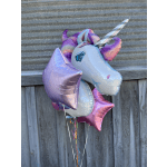Cluster of unicorn-shaped foil balloons with ribbons