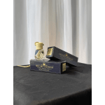 Car diffuser bottle with two black boxes on a table