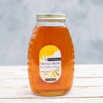 Jar of amber honey with a labeled metal lid