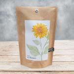 Brown paper seed packet labeled mini sunflower with a yellow flower illustration