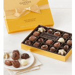 Box of assorted Godiva chocolates with a gold ribbon and lid