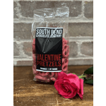 Bag of Valentine pretzels beside a pink rose