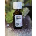 Small amber bottle of Love Potion essential oil blend on crystals