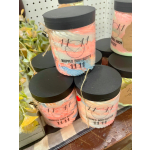 Jars of whipped body butter with black lids and pastel swirls