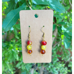 Pair of beaded drop earrings on a cardboard display card