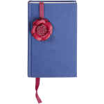 Blue hardcover book with a red ribbon bookmark topped by a decorative flower