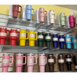 Rows of colorful insulated tumblers displayed on store shelves.
