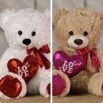 Two teddy bears holding heart pillows with "LOVE" text