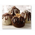 Four chocolate-drizzled dome desserts with cream topping