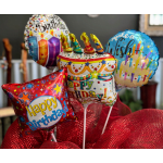 Birthday balloons with candles and a red mesh wrap