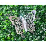 Decorative butterfly ornament on a green leaf wall