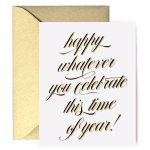 White greeting card with gold script reading 'happy whatever you celebrate this time of year!' and a gold envelope.