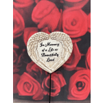 Heart-shaped memorial plaque on a stake with angel wings and text