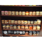 Shelves of assorted scented candles in glass jars and tins