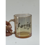 Amber glass mug with the word honey and small bee icons