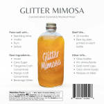 Bottle of glitter mimosa cocktail mixer with orange liquid