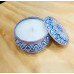 Decorative round candle tin with a white candle inside and patterned lid